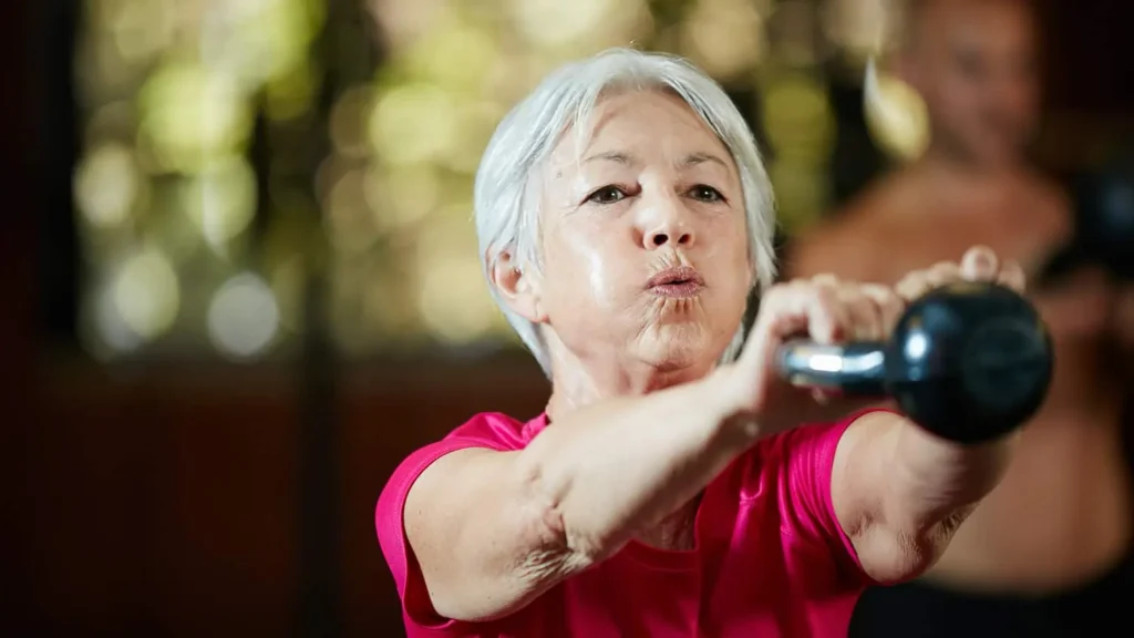 Toning Arms Without the Bulk: Is It Achievable? 1 Woman doing resistance band exercises for toned arms Bellshill